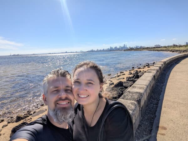 The Melbourne skyline represents the efficiency of the Digital Core; the moments on the sand represent why we build it. This is me and my wife, finding the 'Humanity Signal' on the shores of Port Phillip Bay.
